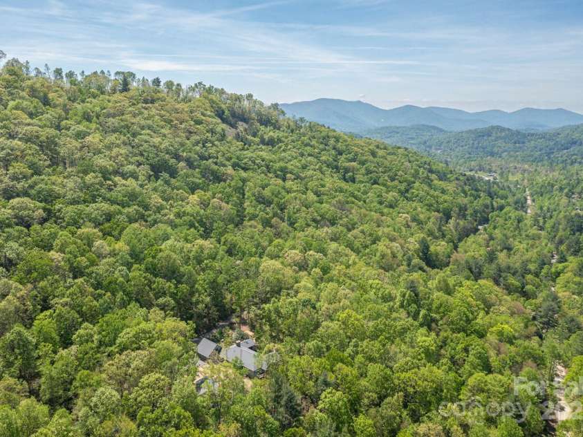 425 Bull Creek Road, Asheville, NC 28805.  MLS# CAR4251410, YatesRealty ID 23105. Bull Creek crosses over your 20-acre estate with private trails leading to Tanbark Ridge and stunning views of the Blue Ridge Parkway.