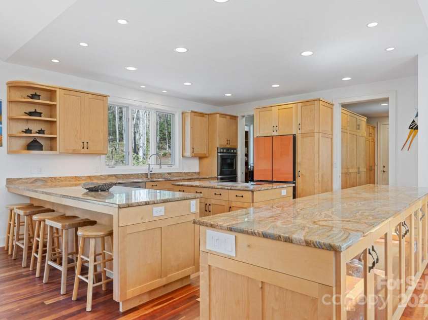 425 Bull Creek Road, Asheville, NC 28805.  MLS# CAR4251410, YatesRealty ID 23105. Elegant kitchen with custom birch cabinetry, granite counters, induction cooktop, and a spacious walk-in butler’s pantry.