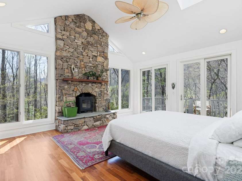 425 Bull Creek Road, Asheville, NC 28805.  MLS# CAR4251410, YatesRealty ID 23105. Impressive light-filled owner's suite featuring a cozy fireplace and private deck.