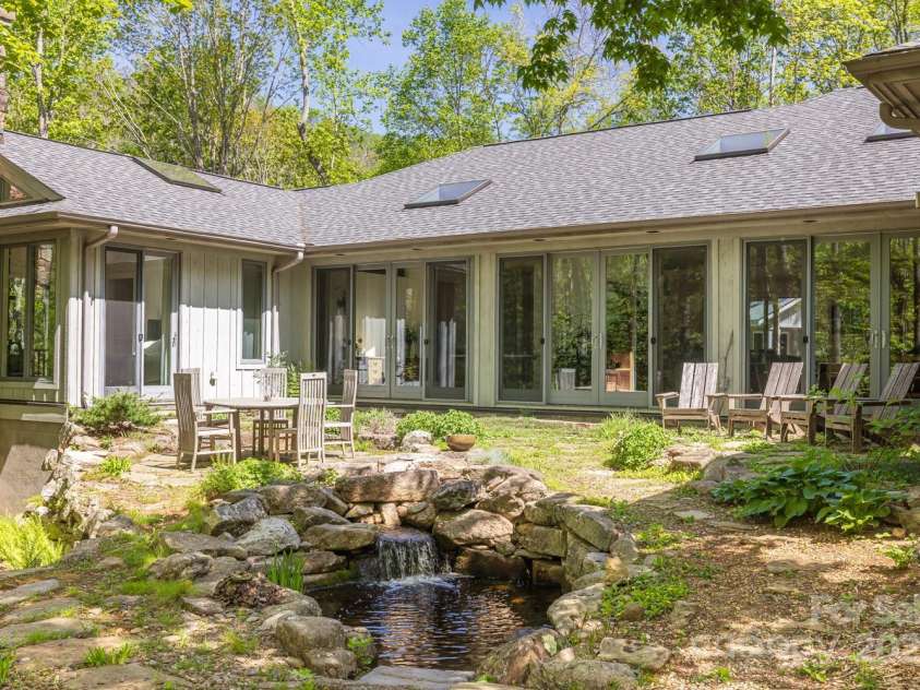 425 Bull Creek Road, Asheville, NC 28805.  MLS# CAR4251410, YatesRealty ID 23105. The property features three captivating water elements, including two serene ponds and a stunning waterfall.