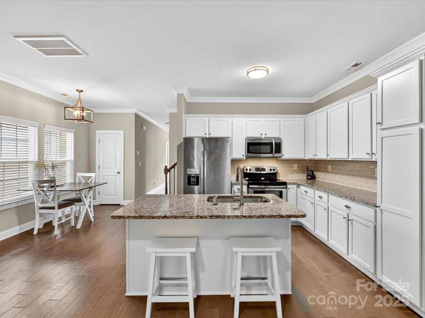 12220 Huntersville Concord Road, Huntersville, NC 28078.  MLS# CAR4301471, YatesRealty ID 23109. Charming Kitchen with beautiful granite tops, white cabinetry, tile backsplash and stainless steal appliances