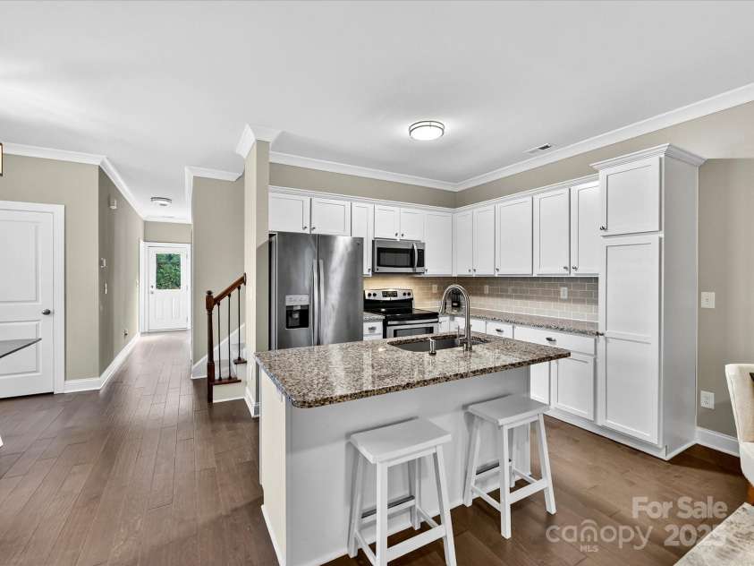 12220 Huntersville Concord Road, Huntersville, NC 28078.  MLS# CAR4301471, YatesRealty ID 23109. Charming Kitchen with beautiful granite tops, white cabinetry, tile backsplash and stainless steal appliances