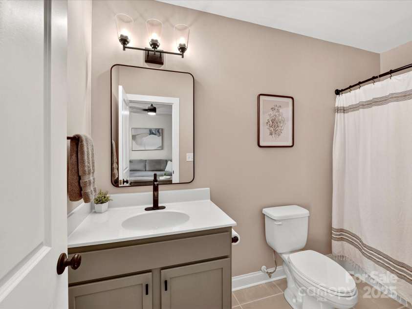 12220 Huntersville Concord Road, Huntersville, NC 28078.  MLS# CAR4301471, YatesRealty ID 23109. Full bathroom with updated vanity , mirror and fixtures. Located in the basement