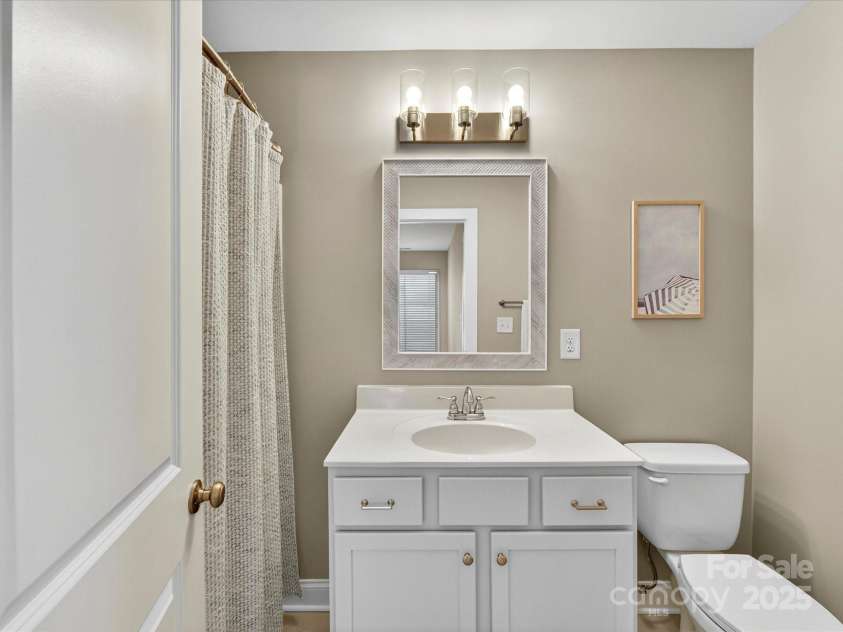 12220 Huntersville Concord Road, Huntersville, NC 28078.  MLS# CAR4301471, YatesRealty ID 23109. Full Bathroom with updated vanity , mirror and light fixture. Located on the upper level .