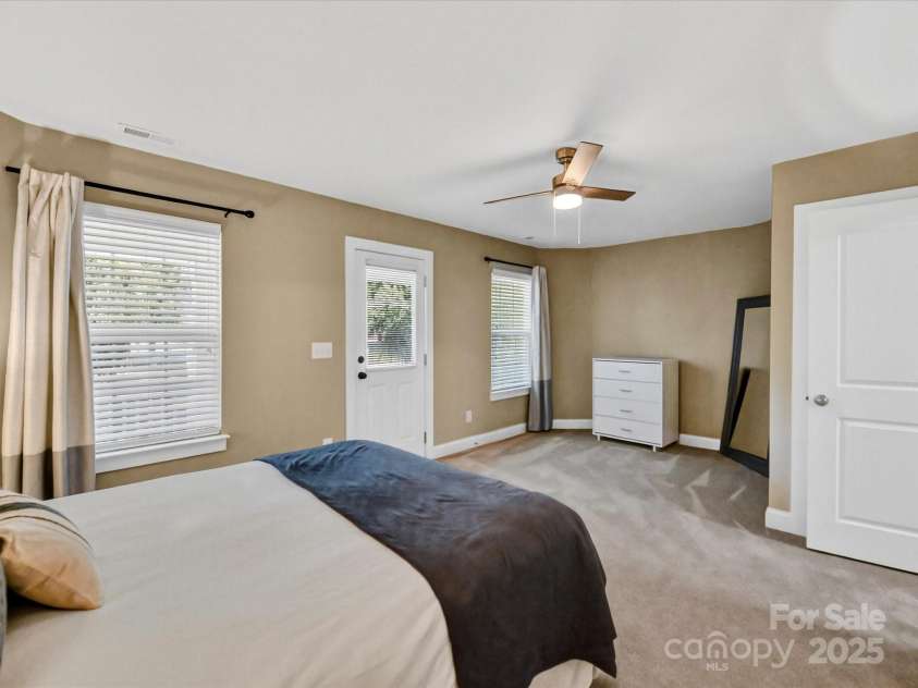 12220 Huntersville Concord Road, Huntersville, NC 28078.  MLS# CAR4301471, YatesRealty ID 23109. Large Primary Bedroom with plush carpeting , renovated primary closet, ensuite bathroom and private balcony!