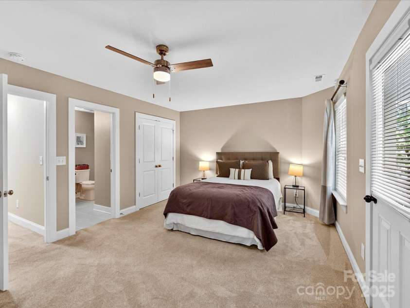 12220 Huntersville Concord Road, Huntersville, NC 28078.  MLS# CAR4301471, YatesRealty ID 23109. Large Primary Bedroom with plush carpeting , renovated primary closet, ensuite bathroom and private balcony!