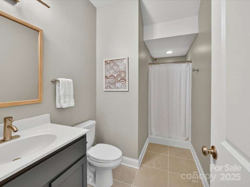 12220 Huntersville Concord Road, Huntersville, NC 28078.  MLS# CAR4301471, YatesRealty ID 23109. Main level Full bathroom with updated sink, vanity, mirror and fixtures