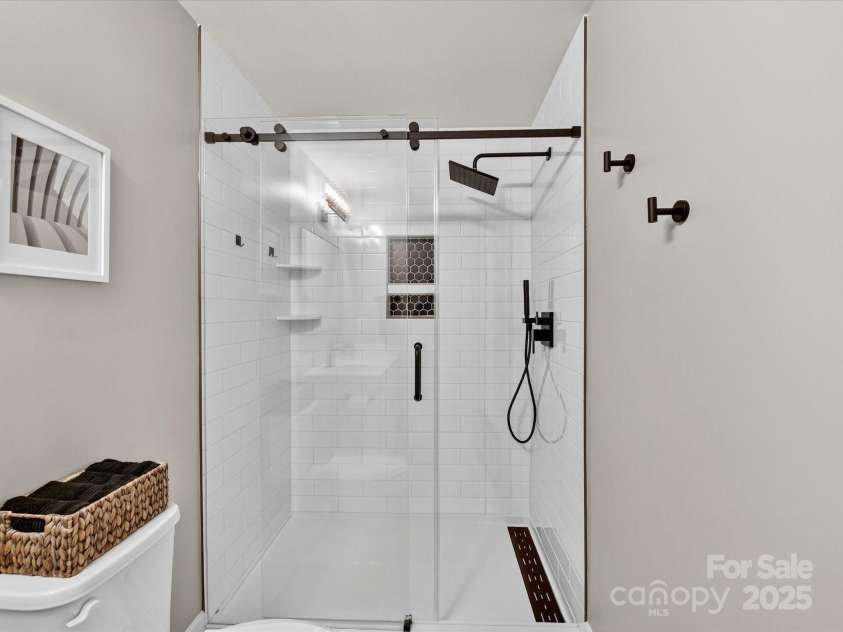 12220 Huntersville Concord Road, Huntersville, NC 28078.  MLS# CAR4301471, YatesRealty ID 23109. Primary bathroom with new vanity , fixtures and elegantly tiled walk in shower
