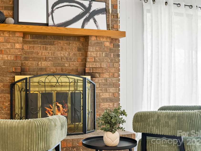 16 Sun Valley Court, Alexander, NC 28701.  MLS# CAR4263633, YatesRealty ID 23110. Den with wood fireplace