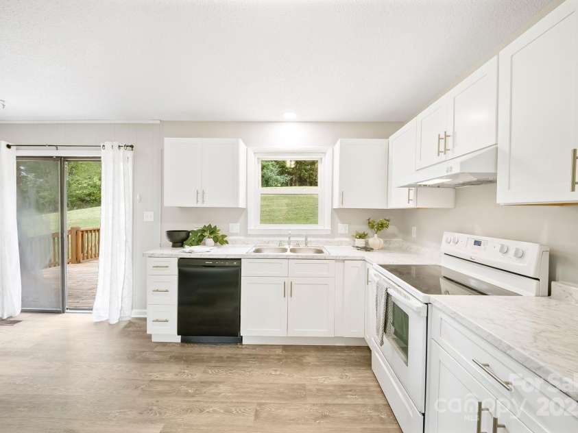 16 Sun Valley Court, Alexander, NC 28701.  MLS# CAR4263633, YatesRealty ID 23110. Light filled kitchen with slider to back deck