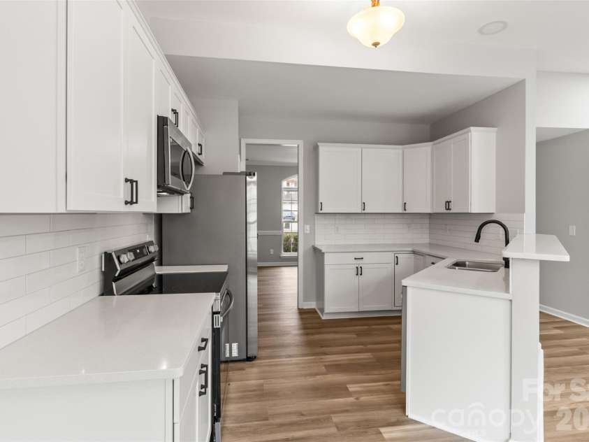 11619 Planters Estates Drive, Charlotte, NC 28278.  MLS# CAR4344590, YatesRealty ID 23116. Great angle to show how large and functional kitchen