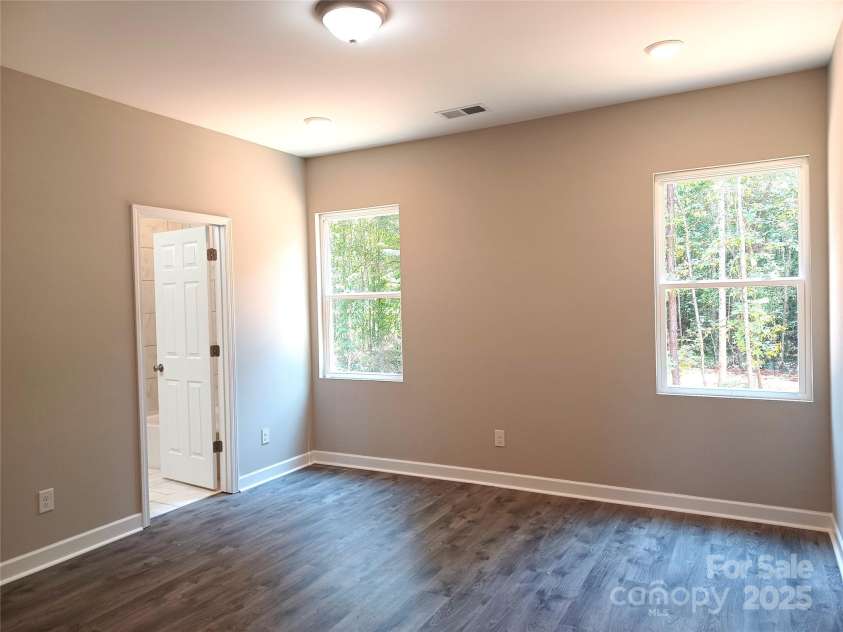 372 Lippard Farm Road, Statesville, NC 28625.  MLS# CAR4275109, YatesRealty ID 23117. Primary Bedroom overlooks peaceful, wooded rear yard