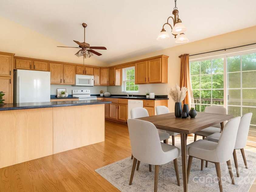 18 & 28 Sunberry Drive, Alexander, NC 28701.  MLS# CAR4266068, YatesRealty ID 23120. AI Digitally Staged Dining Room and Kitchen