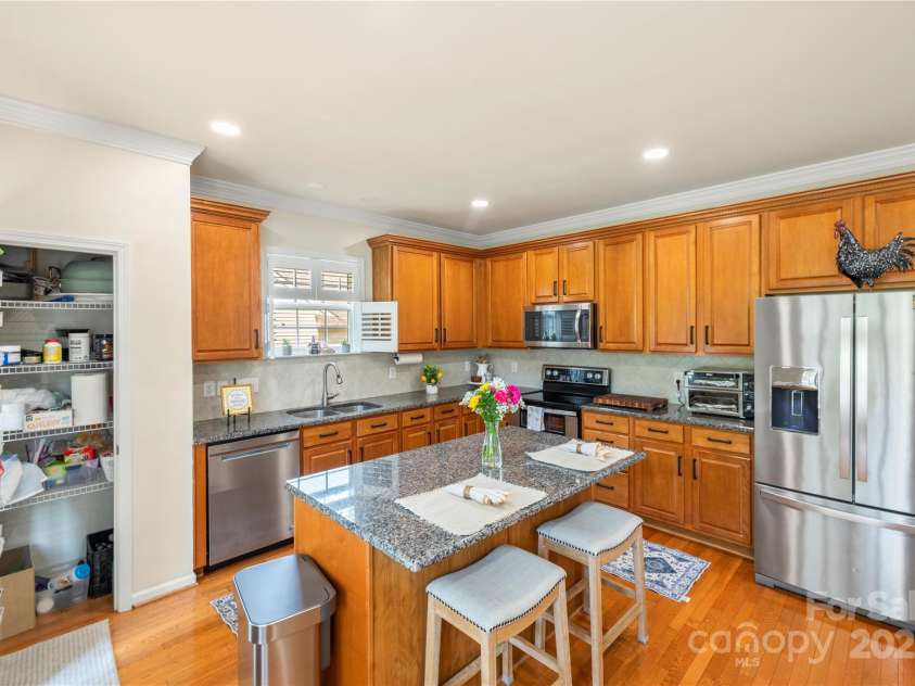 128 Sugar Thyme Lane, Mooresville, NC 28115.  MLS# CAR4266649, YatesRealty ID 23132. Kitchen with island and access to deck