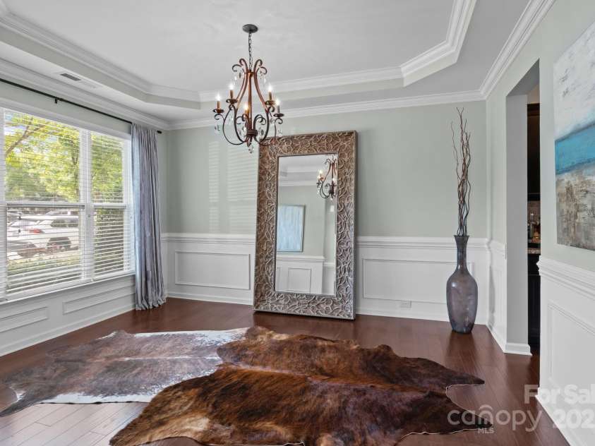 2007 Bishops Court, Cornelius, NC 28031.  MLS# CAR4257347, YatesRealty ID 23133. Dining Room features tray ceiling and decorative molding.
