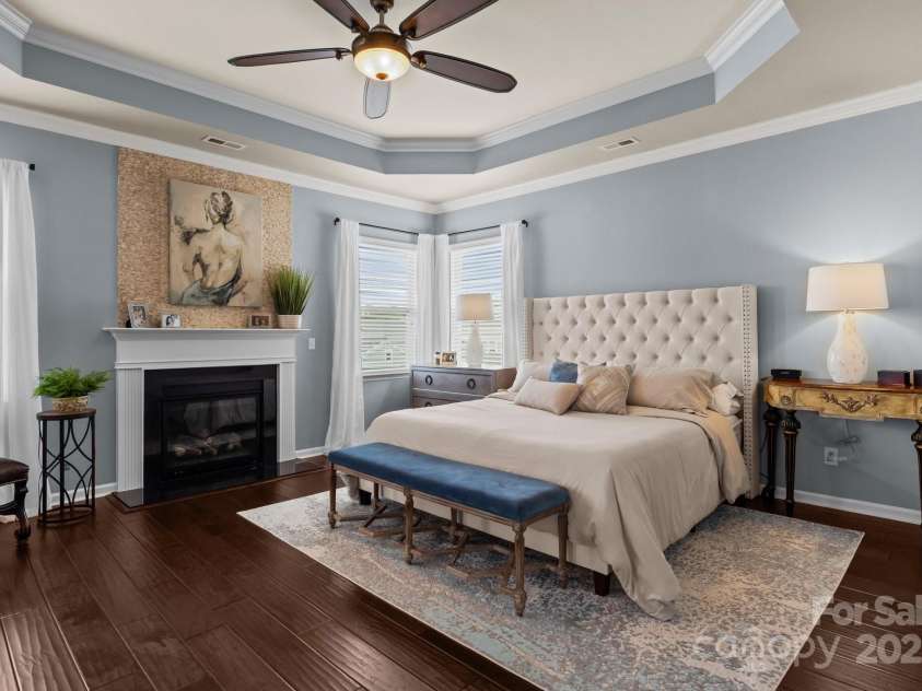 2007 Bishops Court, Cornelius, NC 28031.  MLS# CAR4257347, YatesRealty ID 23133. HUGE Primary Bedroom features hardwoods, tray ceiling, crown molding and a fabulous fireplace!