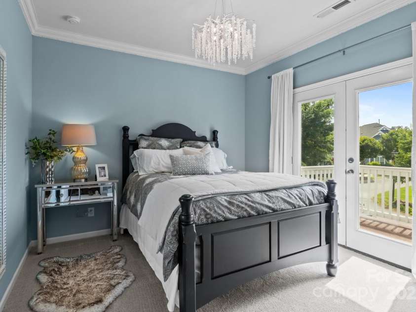 2007 Bishops Court, Cornelius, NC 28031.  MLS# CAR4257347, YatesRealty ID 23133. Secondary Bedroom has walk-in closet and balcony that overlooks community green area.