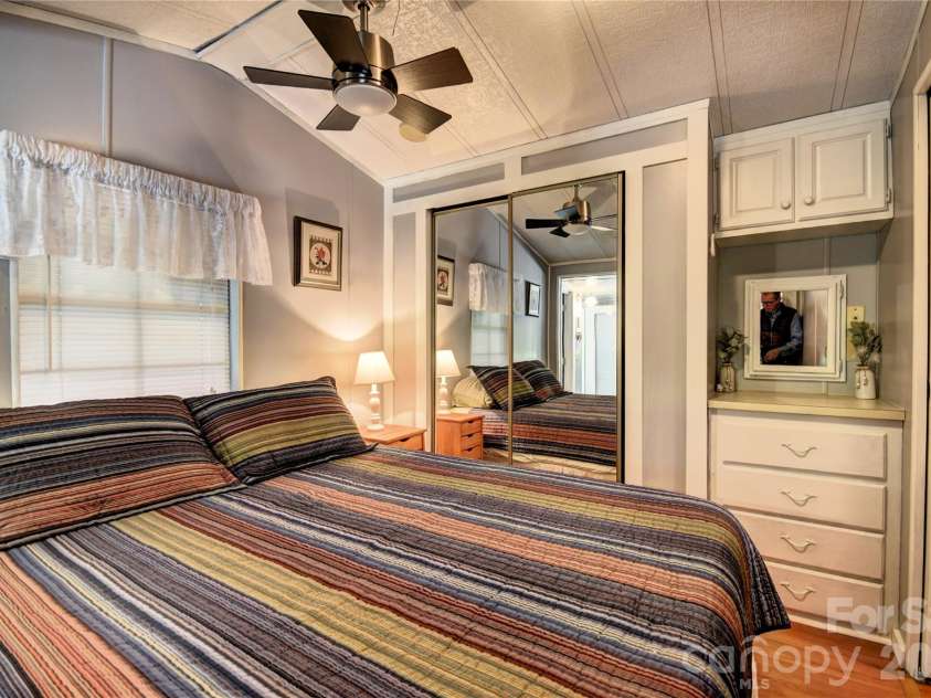91 Mallard Loop, Waynesville, NC 28785.  MLS# CAR4372848, YatesRealty ID 23150. Bedroom 2 with built-ins and mirrored closet doors