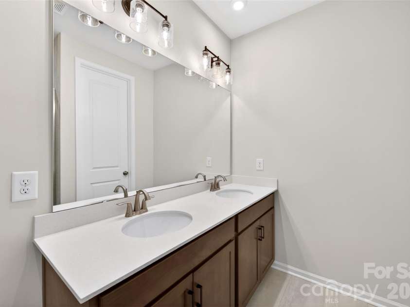 6025 Longar Lane, Charlotte, NC 28269.  MLS# CAR4376910, YatesRealty ID 23163. Dual vanity primary bathroom