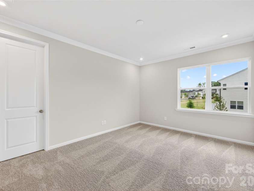 6025 Longar Lane, Charlotte, NC 28269.  MLS# CAR4376910, YatesRealty ID 23163. Light filled primary bedroom