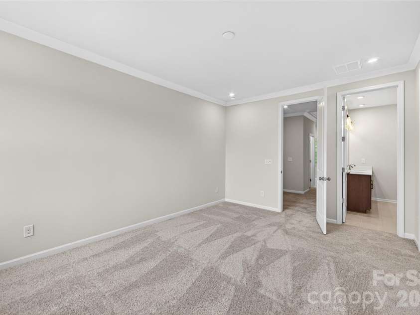 6025 Longar Lane, Charlotte, NC 28269.  MLS# CAR4376910, YatesRealty ID 23163. Light filled primary bedroom