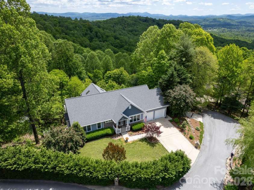 105 Spring Path, Hendersonville, NC 28739.  MLS# CAR4256171, YatesRealty ID 2317. Front Hedge borders Rowland