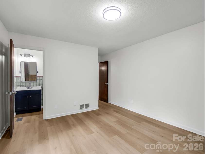 11 Deer Run Drive, Asheville, NC 28803.  MLS# CAR4377673, YatesRealty ID 23171. New vanity and more in primary bath