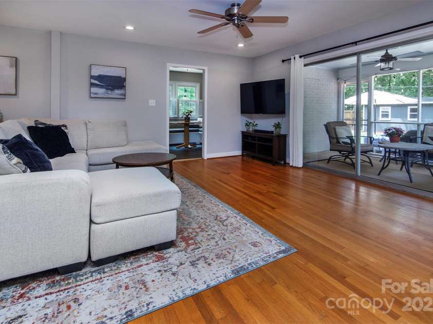 1427 Worcaster Place, Charlotte, NC 28211.  MLS# CAR4252572, YatesRealty ID 23180. Family room with sliders to screened in porch...