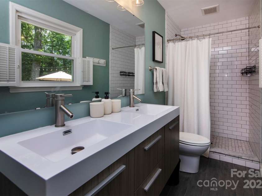 1427 Worcaster Place, Charlotte, NC 28211.  MLS# CAR4252572, YatesRealty ID 23180. Primary bath with barn door...