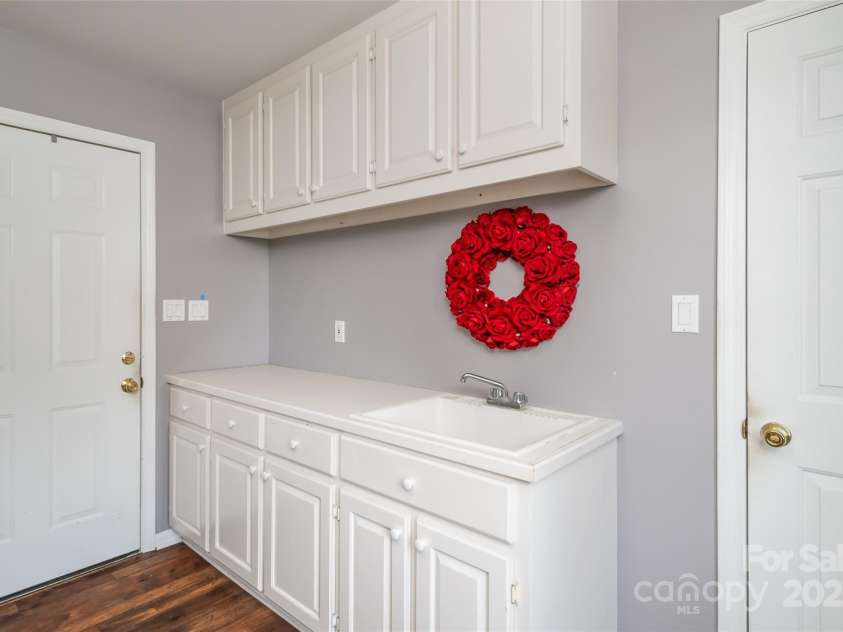 139 Hardwick Drive, Mooresville, NC 28115.  MLS# CAR4270684, YatesRealty ID 23196. Laundry room offers cabinetry for storage and a sink.