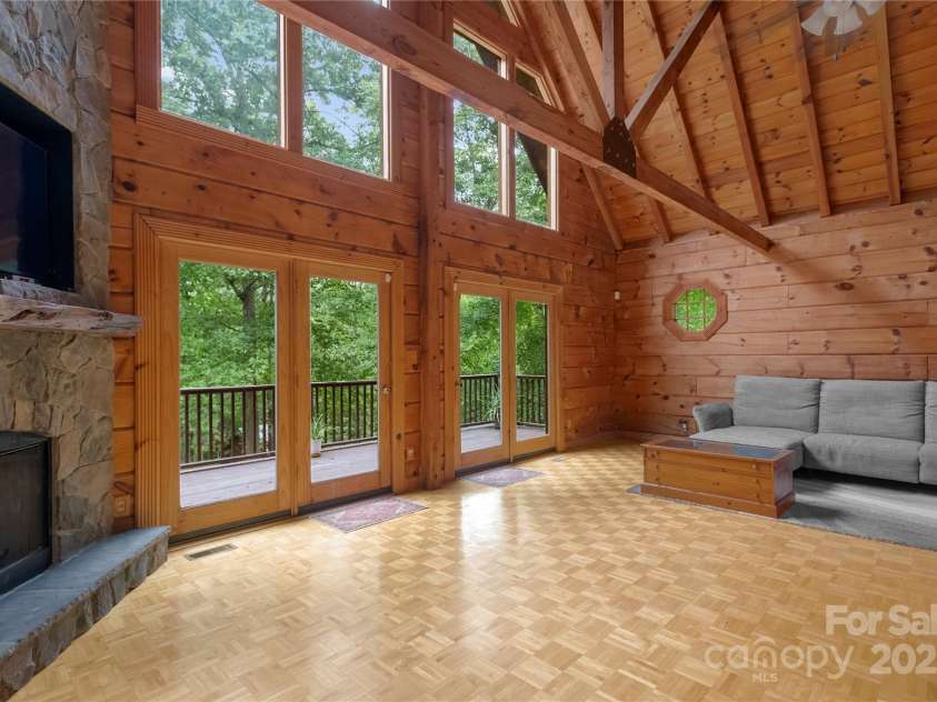 720 Potneck Road, Salisbury, NC 28147.  MLS# CAR4270437, YatesRealty ID 23205. Great room with wall of windows overlooking woods