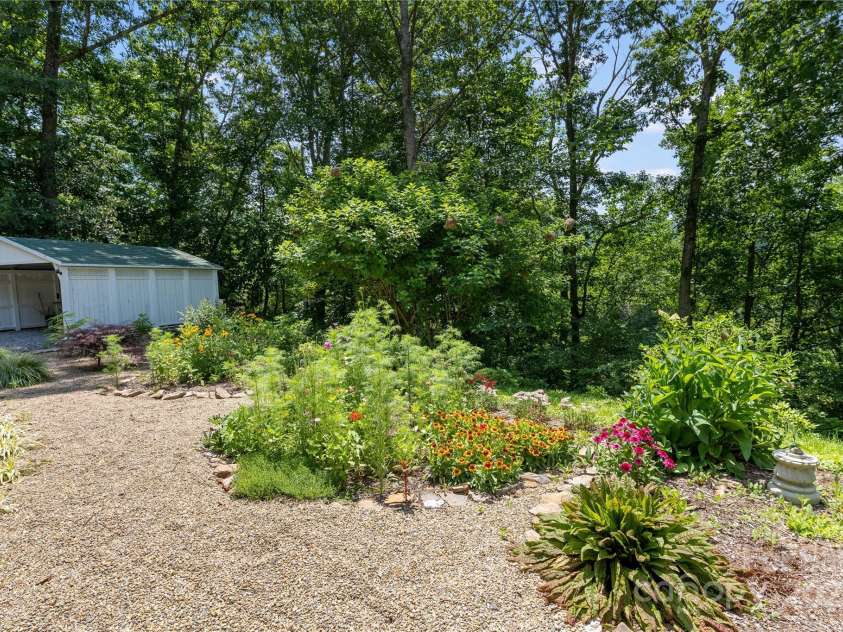 109 Paradise Circle, Clyde, NC 28721.  MLS# CAR4239920, YatesRealty ID 23219. Gardens and carport for storage and covered parking!