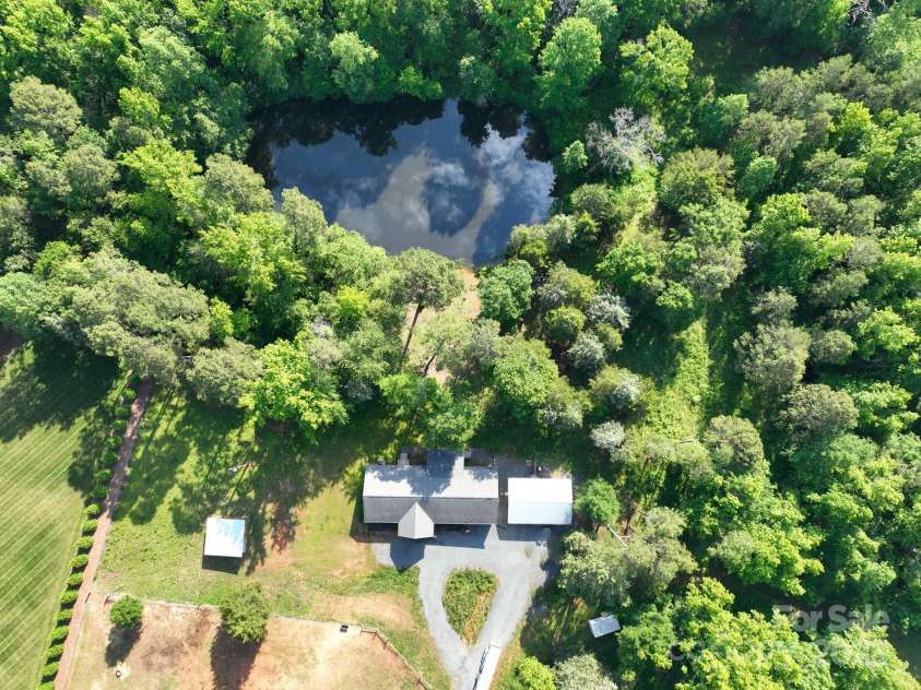 16132 Mclester Road, Oakboro, NC 28129.  MLS# CAR4263012, YatesRealty ID 23221. Aerial view showing pond