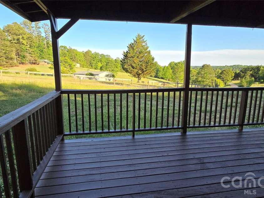 78 Buck Branch Road, Mill Spring, NC 28756.  MLS# CAR4381478, YatesRealty ID 23248. Large covered front porch with peaceful views
