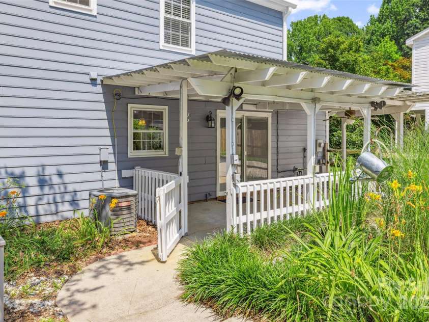 4911 Rivergreen Lane, Charlotte, NC 28227.  MLS# CAR4272250, YatesRealty ID 23250. Coverd porch overlooking the private backyard and pool