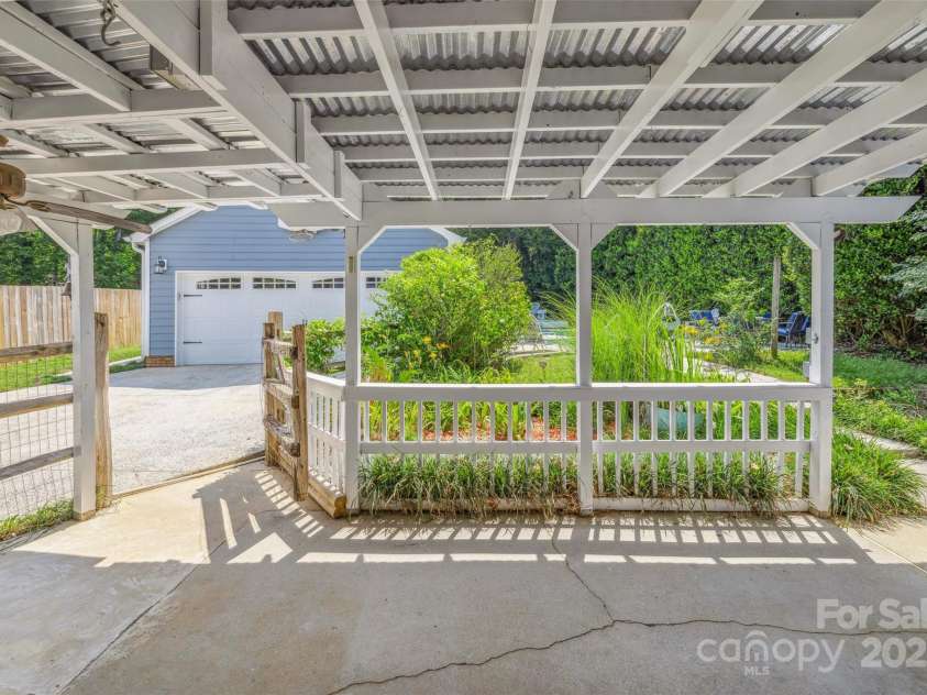 4911 Rivergreen Lane, Charlotte, NC 28227.  MLS# CAR4272250, YatesRealty ID 23250. Covered porch overlooking the backyard