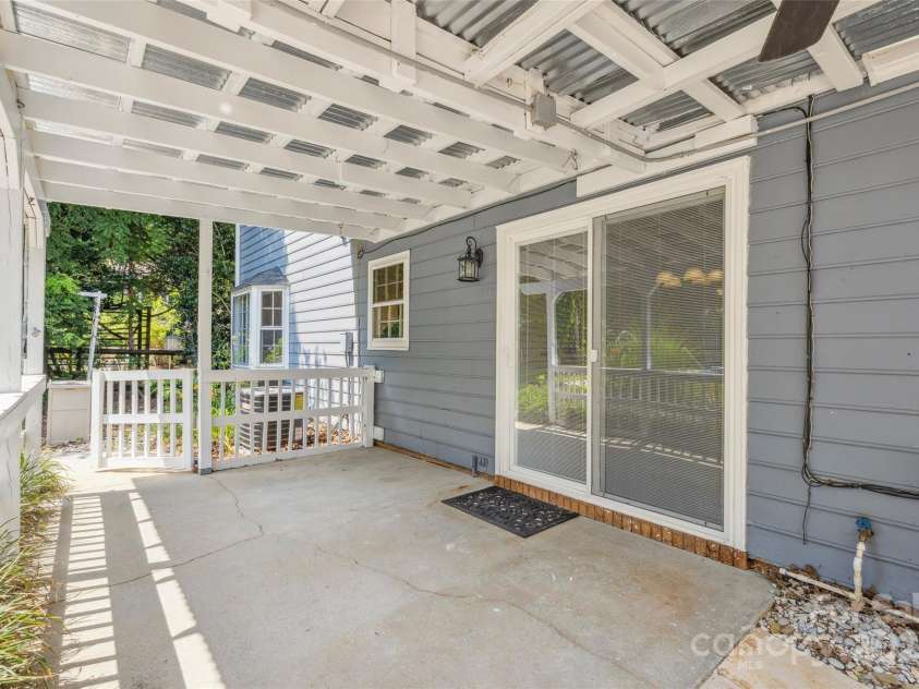 4911 Rivergreen Lane, Charlotte, NC 28227.  MLS# CAR4272250, YatesRealty ID 23250. Covered rear porch overlooking the private yard/pool