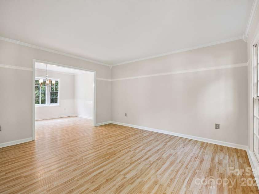 4911 Rivergreen Lane, Charlotte, NC 28227.  MLS# CAR4272250, YatesRealty ID 23250. Large living room/flex room and dining room