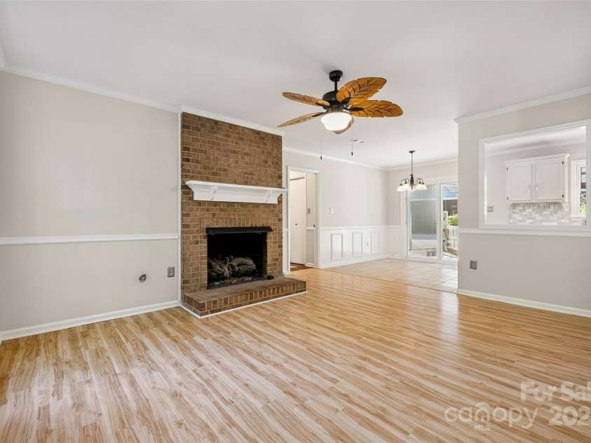 4911 Rivergreen Lane, Charlotte, NC 28227.  MLS# CAR4272250, YatesRealty ID 23250. Living room with gas fireplace and breakfast area