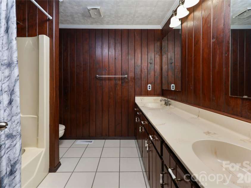 7362 Volunteer Rescue Road, Denton, NC 27239.  MLS# CAR4370916, YatesRealty ID 23257. Hall bath with double vanity and tile floors