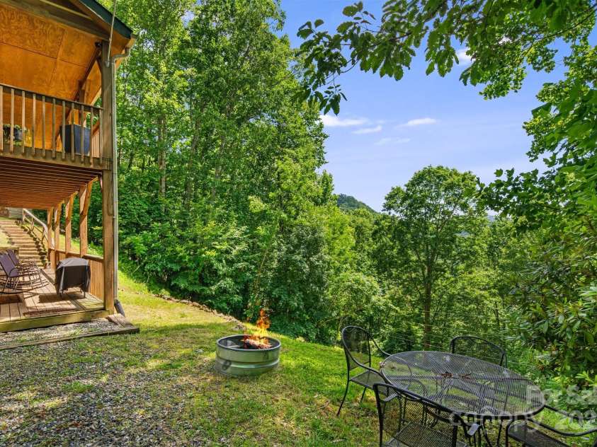 110 Red Wolf Lane, Mars Hill, NC 28754.  MLS# CAR4239848, YatesRealty ID 2326. Side of house with fire pit