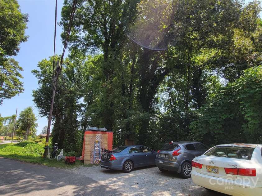 160 Cleveland Road, Tryon, NC 28782.  MLS# CAR4274322, YatesRealty ID 23261. Parking to the left of structure