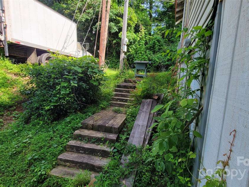 160 Cleveland Road, Tryon, NC 28782.  MLS# CAR4274322, YatesRealty ID 23261. Stairs from right of basement