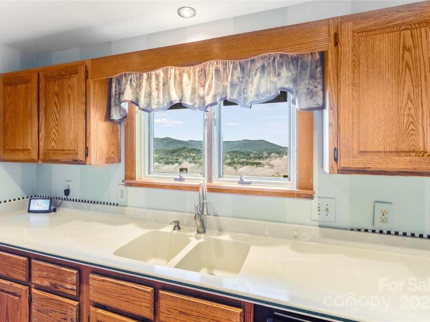 1087 Brigadoon Drive, Clyde, NC 28721.  MLS# CAR4276623, YatesRealty ID 23272. Great views from kitchen