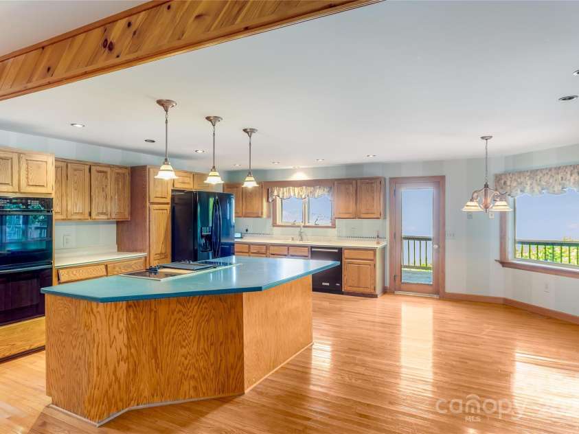 1087 Brigadoon Drive, Clyde, NC 28721.  MLS# CAR4276623, YatesRealty ID 23272. Open kitchen and den