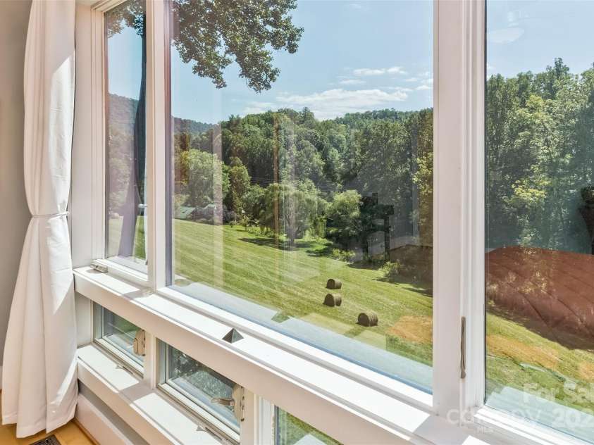 404 Amanda Drive, Mars Hill, NC 28754.  MLS# CAR4232022, YatesRealty ID 2330. Looking out over the meadows and pond below