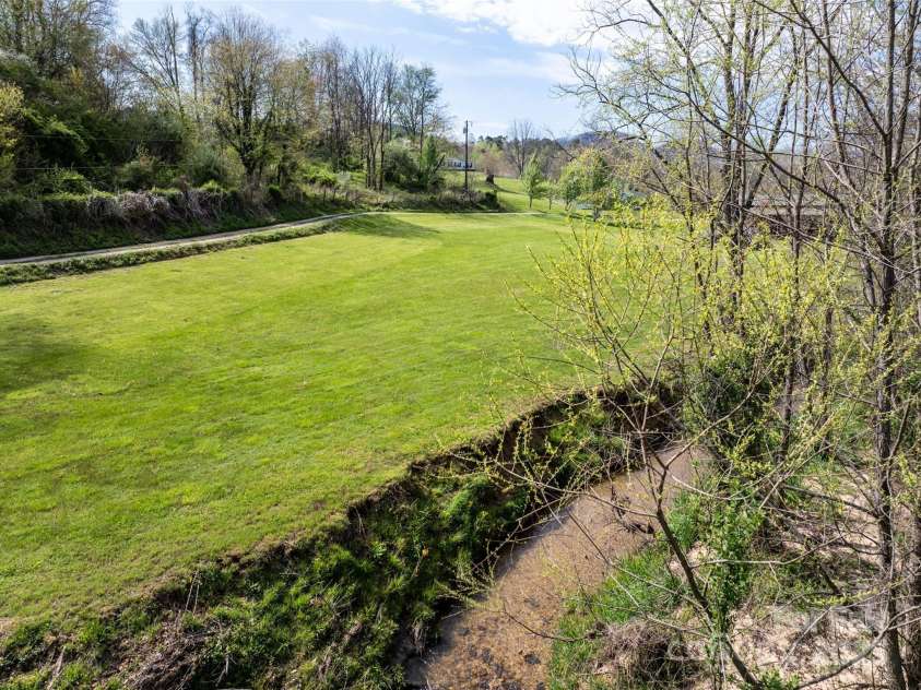 20 & 28 Toby Drive, Asheville, NC 28806.  MLS# CAR4261356, YatesRealty ID 23300. Creek frontage on the property.