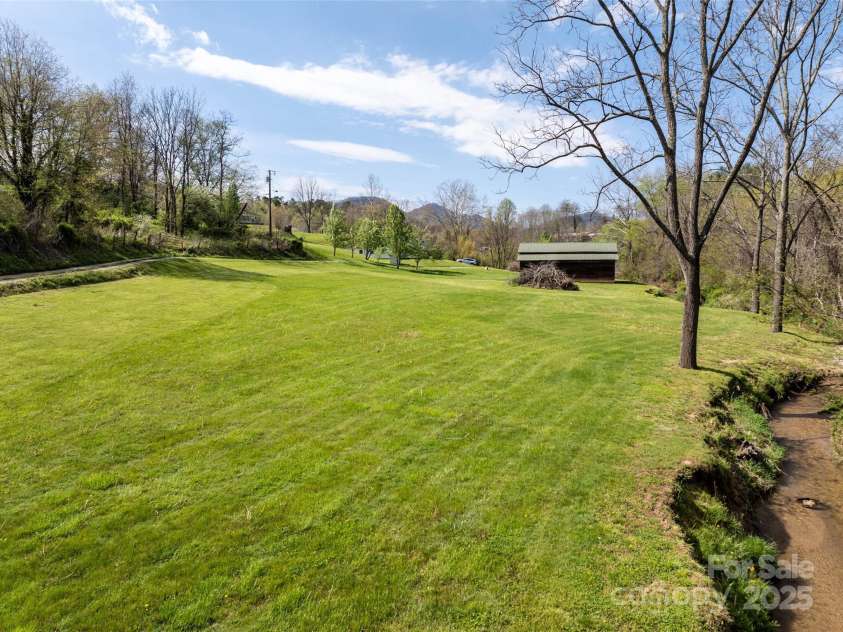 20 & 28 Toby Drive, Asheville, NC 28806.  MLS# CAR4261356, YatesRealty ID 23300. Lots of room for potential development with creek frontage.
