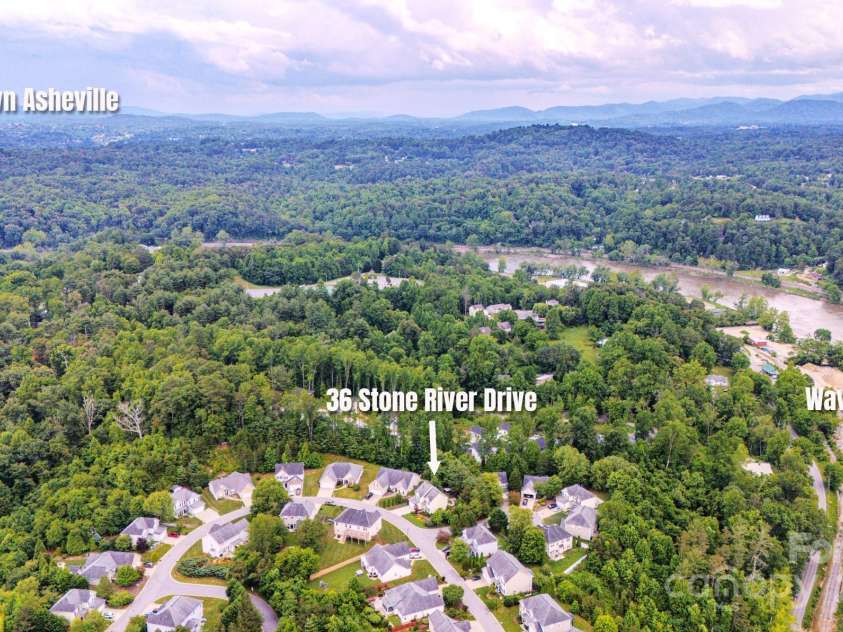 36 Stone River Drive, Asheville, NC 28804.  MLS# CAR4268666, YatesRealty ID 23301. Aerial view showing downtown and proximity to French Broad River and new wave park.