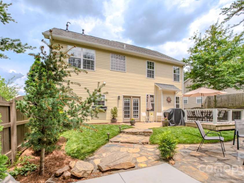 36 Stone River Drive, Asheville, NC 28804.  MLS# CAR4268666, YatesRealty ID 23301. Flagstone path and deck leads to a hot tub pad(grey plastic squares) with electric hookup in place and ready to go!